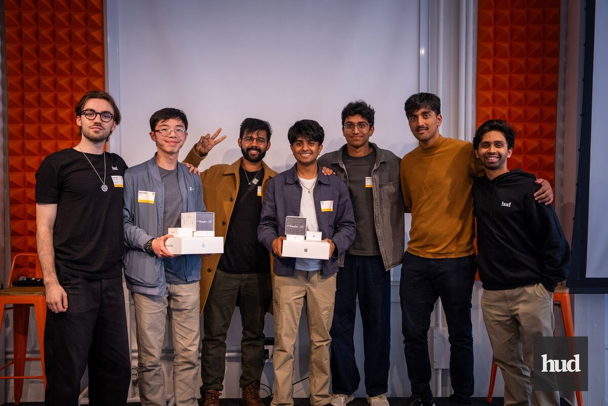 Aneesh with his team holding prizes at the HUD hackathon