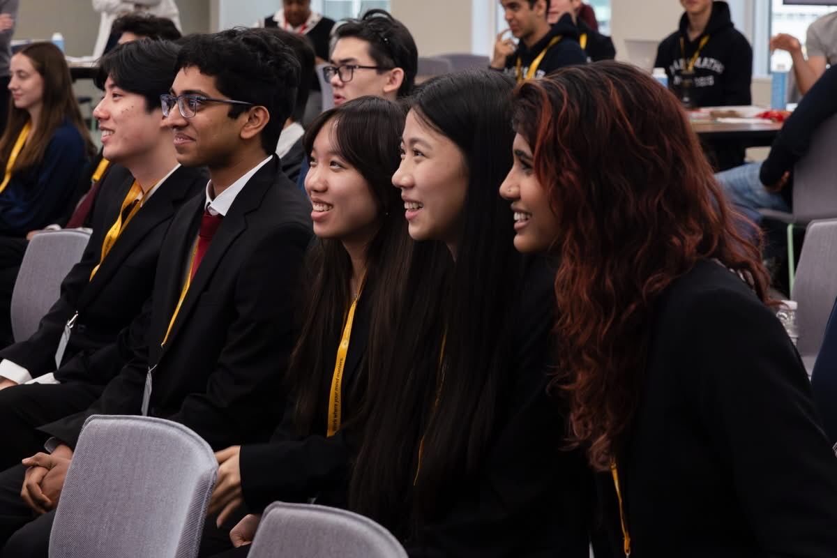 Aneesh smiling with his team at the M3 Challenge finals
